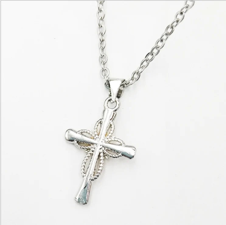 Silver cross necklace on a white background