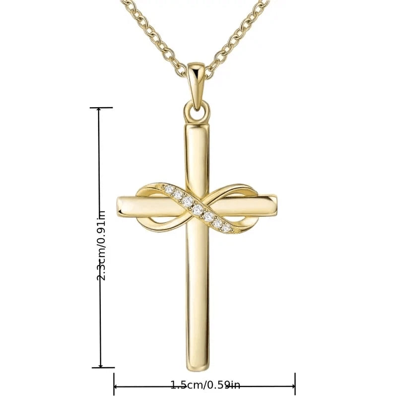 Gold cross pendant necklace with an infinity symbol across the center set with small clear stones, shown on a white background with dimension lines indicating 2.3 cm height and 1.