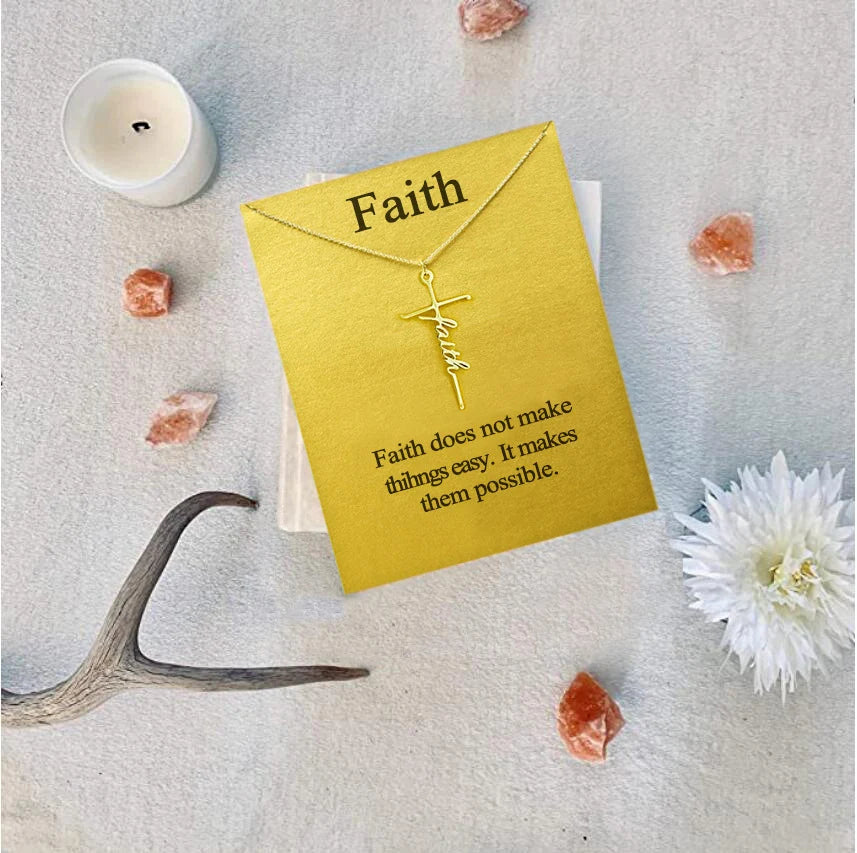 Gold cross necklace on a yellow card with 'Faith' text, surrounded by crystals and a candle.