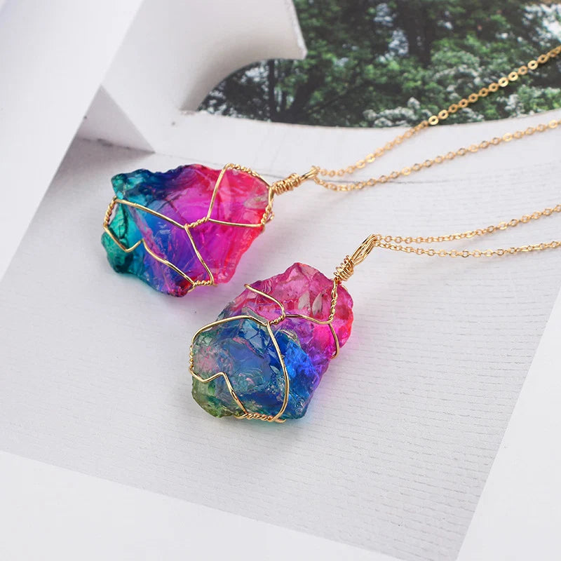 Colorful stone pendant necklace on a white surface with a blurred natural background