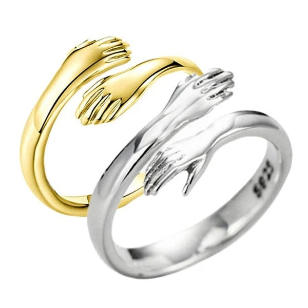 Adjustable hug ring with hugging hands design in gold and sterling silver