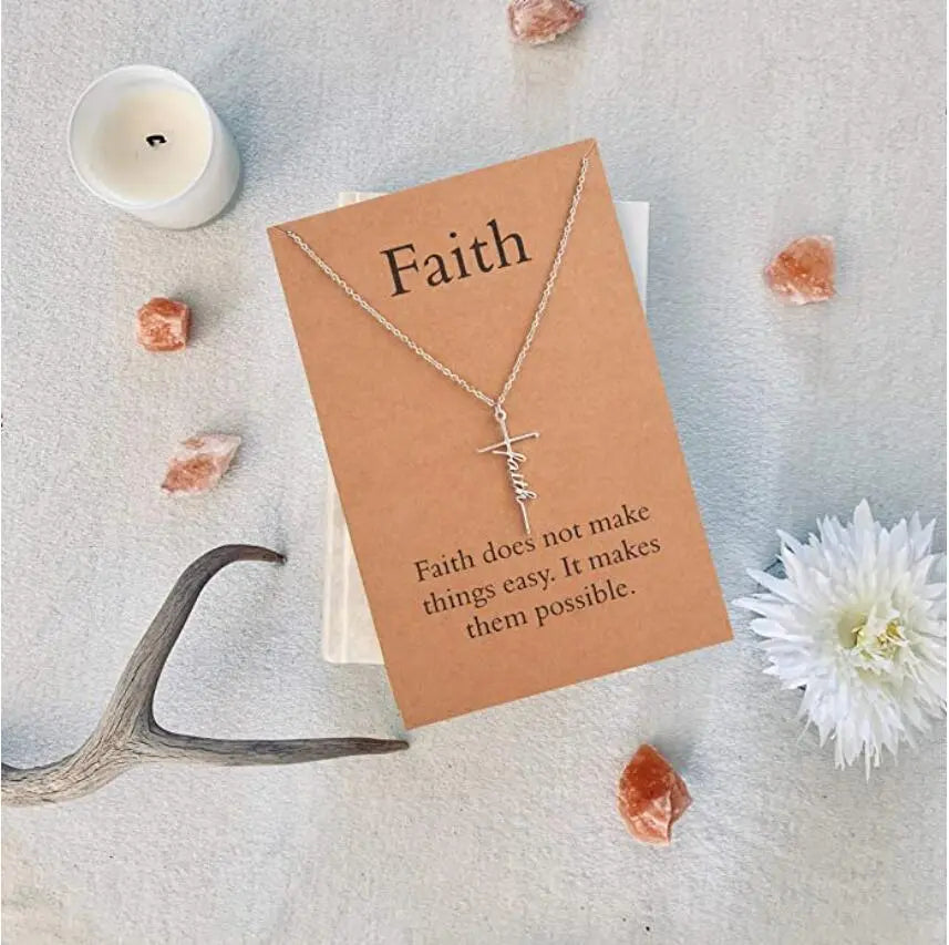 Necklace with cross pendant on a card with 'Faith' text, surrounded by crystals and a candle.