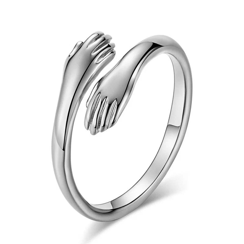 Silver open ring with hand design on a white background