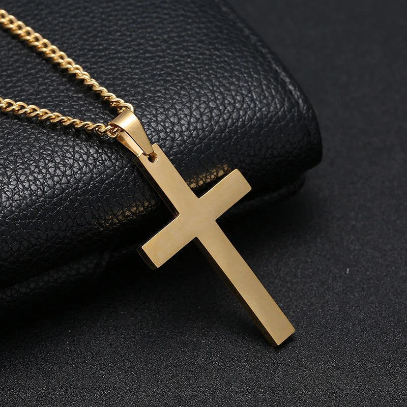 Gold cross pendant on a chain against a black textured background
